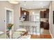 Open kitchen with a breakfast bar, dark wood cabinets, stainless steel appliances, and bright lighting at 1532 Meade St, Denver, CO 80204