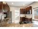 A kitchen with granite countertops, stainless steel appliances and dark wood cabinetry at 1532 Meade St, Denver, CO 80204