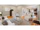 Bright living room featuring hardwood floors, a stylish rug, and an open layout flowing into the dining area at 1532 Meade St, Denver, CO 80204