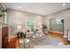 Cozy living room with hardwood floors, a comfortable sofa, and a bright window with outdoor views at 1532 Meade St, Denver, CO 80204