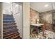 Unique staircase leading to a brick-walled space with desk and chair at 1532 Meade St, Denver, CO 80204