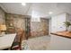 Basement storage room with brick walls, utility sink, counter space, and ski storage at 1532 Meade St, Denver, CO 80204