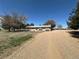 Charming ranch-style home with a gravel driveway and mature trees on a spacious lot at 1685 E 160Th Ave, Broomfield, CO 80023