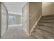 Carpeted basement featuring staircase, doors, and window at 4214 Kestrel Pl, Castle Rock, CO 80109