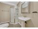 Well lit bathroom features a glass enclosed shower, pedestal sink, and neutral color palette at 4214 Kestrel Pl, Castle Rock, CO 80109