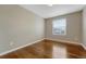 Bedroom featuring hardwood floors, neutral walls, and a window with blinds at 4214 Kestrel Pl, Castle Rock, CO 80109