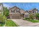 Well-kept home shows a lush lawn, driveway, complementary landscaping, and neutral colored siding at 4214 Kestrel Pl, Castle Rock, CO 80109