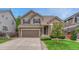 Charming home features a two-car garage, a well-maintained lawn, and neutral colored siding at 4214 Kestrel Pl, Castle Rock, CO 80109