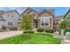 Lovely home has a vibrant green lawn, a mature tree, and pleasing landscaping at 4214 Kestrel Pl, Castle Rock, CO 80109