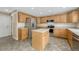 Modern kitchen with stainless steel appliances, a center island, and light wood cabinets at 4214 Kestrel Pl, Castle Rock, CO 80109