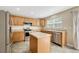 Kitchen with stainless steel appliances, center island, and light wood cabinets at 4214 Kestrel Pl, Castle Rock, CO 80109