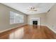 Bright living room featuring hardwood floors, a fireplace, and a large window at 4214 Kestrel Pl, Castle Rock, CO 80109