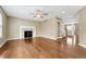 Spacious living room with hardwood floors and a fireplace with white mantle at 4214 Kestrel Pl, Castle Rock, CO 80109