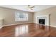 Inviting room showcases hardwood floors, a ceiling fan, and a cozy fireplace at 4214 Kestrel Pl, Castle Rock, CO 80109
