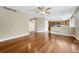 Open living room with hardwood floors, neutral paint, and a ceiling fan at 4214 Kestrel Pl, Castle Rock, CO 80109