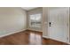 Bright living room boasts hardwood floors, large window, and neutral walls at 4214 Kestrel Pl, Castle Rock, CO 80109