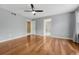 Large main bedroom with hardwood floors, ceiling fan, and ensuite bathroom at 4214 Kestrel Pl, Castle Rock, CO 80109