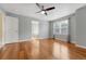 Spacious main bedroom with hardwood floors, ceiling fan, and large windows at 4214 Kestrel Pl, Castle Rock, CO 80109