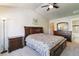 Bright bedroom with ceiling fan, vaulted ceiling, and dresser with attached mirror at 12766 Jasmine St # D, Thornton, CO 80602