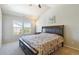 Light-filled bedroom featuring a vaulted ceiling, ceiling fan, and comfortable bed at 12766 Jasmine St # D, Thornton, CO 80602