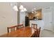 Cozy dining area features a wooden table and chairs, flowing seamlessly into the kitchen space at 12766 Jasmine St # D, Thornton, CO 80602