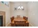 Inviting dining space with a large wooden table, chairs and chandelier lighting, perfect for gatherings at 12766 Jasmine St # D, Thornton, CO 80602