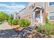 Attractive townhome with stone and siding exterior, set on landscaped grounds with a concrete walkway, creating a pleasant entryway at 12766 Jasmine St # D, Thornton, CO 80602