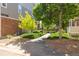 Landscaped front yard featuring lush greenery, sidewalk, and a well-maintained lawn at 12766 Jasmine St # D, Thornton, CO 80602