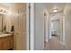 Hallway view with bathroom vanity to the left and bedroom entrance at the end of the hall at 12766 Jasmine St # D, Thornton, CO 80602