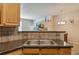 Well-equipped kitchen boasts ample counter space, stylish backsplash, and stainless steel sink at 12766 Jasmine St # D, Thornton, CO 80602