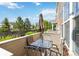 Inviting patio area with a glass table, seating for four, and a shade umbrella at 12766 Jasmine St # D, Thornton, CO 80602