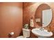 Stylish powder room with modern vanity, decorative mirror, and elegant fixtures at 12766 Jasmine St # D, Thornton, CO 80602