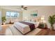Light-filled bedroom featuring a large window, hardwood floors, and a plush, inviting king-size bed at 9335 E Center Ave # 7B, Denver, CO 80247