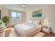 Comfortable bedroom features a serene atmosphere with a large window and queen-sized bed at 9335 E Center Ave # 7B, Denver, CO 80247