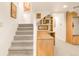 A carpeted basement features stairs and custom wooden built-ins perfect for storage and organization at 506 N Marion St, Denver, CO 80218
