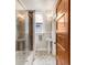 Bathroom with pedestal sinks, hexagon tile floor, and a glass-enclosed shower at 506 N Marion St, Denver, CO 80218