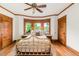 Cozy bedroom with natural light, hardwood floors, and a stylish gold metal bed frame at 506 N Marion St, Denver, CO 80218