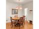 Charming dining room with hardwood floors, vintage chandelier, and adjacent bathroom at 506 N Marion St, Denver, CO 80218