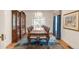 Spacious dining room with large table, china cabinet, and large windows for lots of natural light at 506 N Marion St, Denver, CO 80218