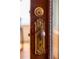 Ornate antique doorknob and lock with a detailed plate on a dark stained door at 506 N Marion St, Denver, CO 80218