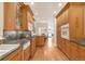 Galley kitchen featuring custom cabinets, granite counters, and stainless steel appliances at 506 N Marion St, Denver, CO 80218