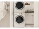 Convenient laundry room with stacked washer/dryer, black countertop, and ample cabinet space at 506 N Marion St, Denver, CO 80218