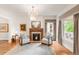Elegant living room featuring a fireplace, chandelier, and hardwood floors at 506 N Marion St, Denver, CO 80218