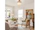Well-lit living room featuring a bay window, comfortable seating, and a vintage piano at 506 N Marion St, Denver, CO 80218