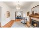 Bright living room featuring hardwood floors, fireplace, and a view into the adjacent dining room at 506 N Marion St, Denver, CO 80218
