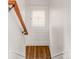 Staircase landing featuring a stained glass window and hardwood floors at 506 N Marion St, Denver, CO 80218
