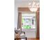 Living room window featuring an elegant chandelier, custom drapes, and ornate trim at 506 N Marion St, Denver, CO 80218