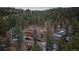 Secluded multi-structure home nestled in a dense forest, offering privacy and a scenic view at 6080 Kilimanjaro Dr, Evergreen, CO 80439