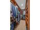 This walk-in closet has custom wood shelving and hanging rods for maximum storage and organization at 6080 Kilimanjaro Dr, Evergreen, CO 80439