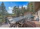 Expansive deck offering incredible mountain views and featuring a dining table and outdoor grill at 6080 Kilimanjaro Dr, Evergreen, CO 80439